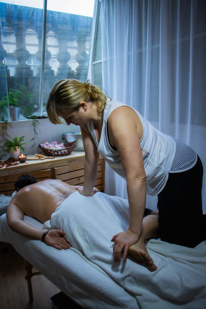 Massuer doing deep back massage